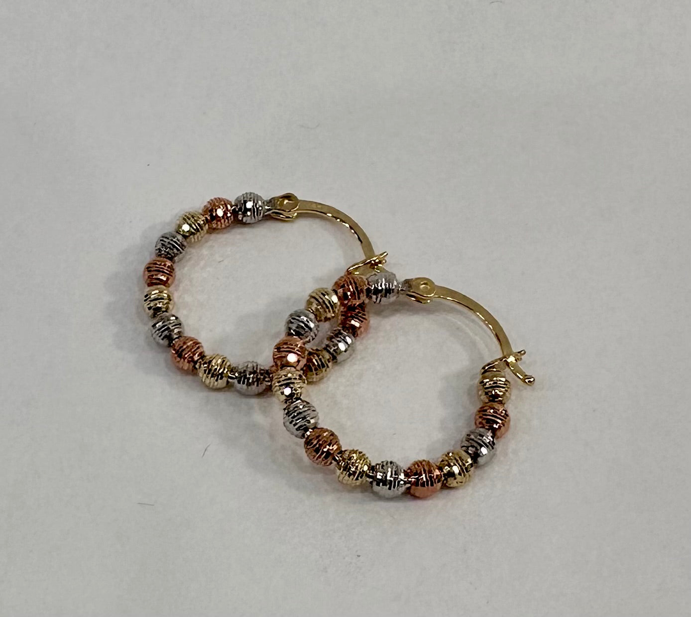 three colored gold ball hoops