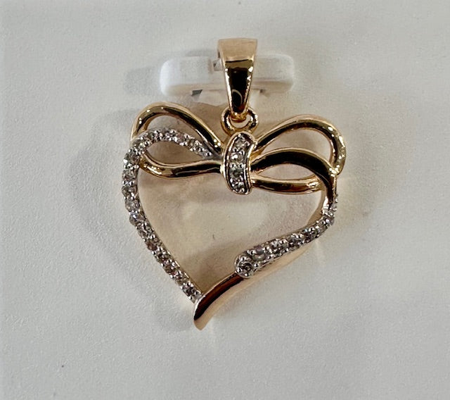 Natural diamond and gold heart pendant with a bow