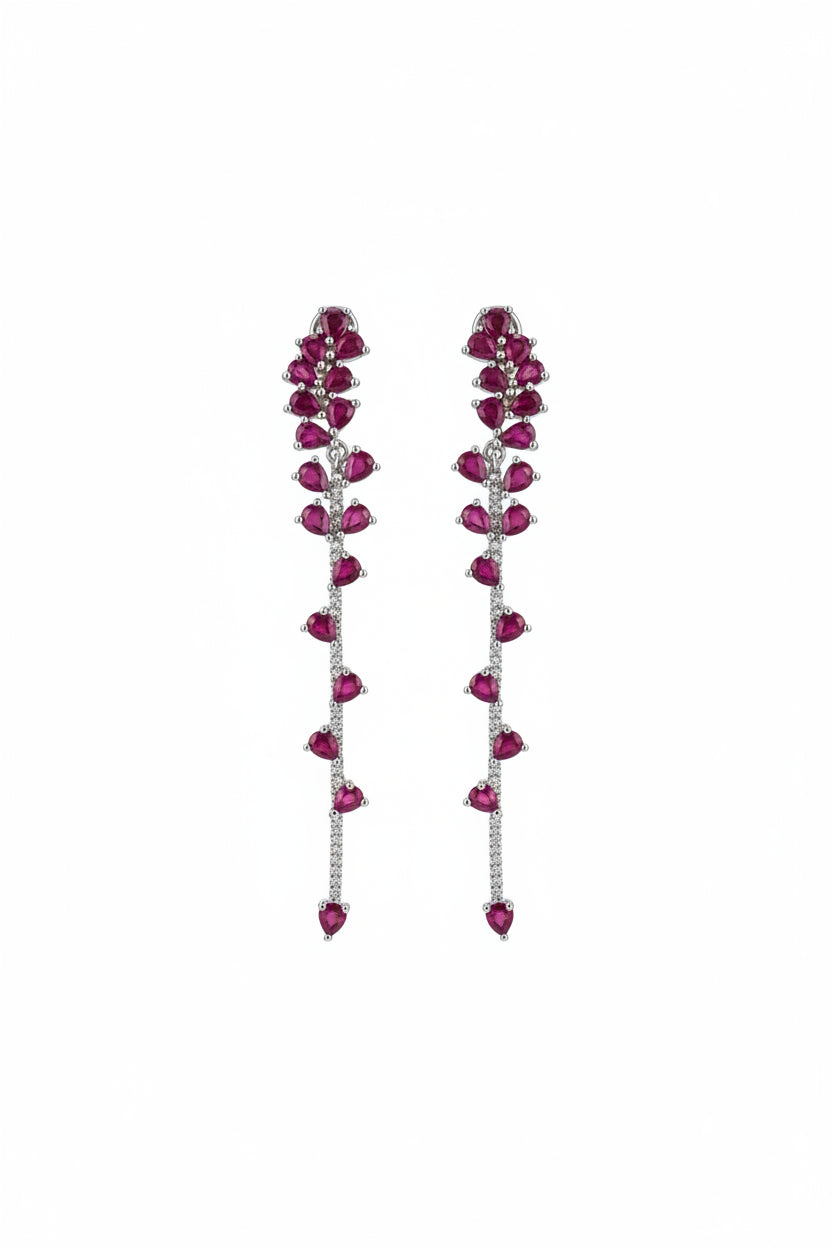 dangling ruby earrings on white background