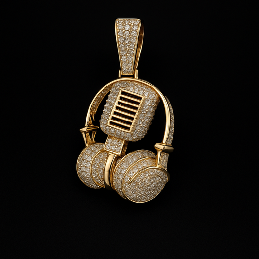 Gold headphone-shaped pendant with diamond accents on a black background
